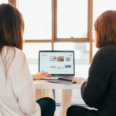 Two people looking at laptop computer